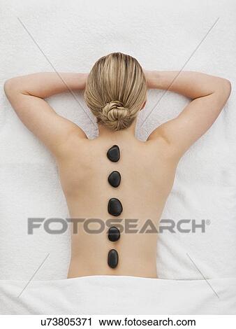 Woman receiving la stone therapy View Large Photo Image Stock Image - Woman receiving la stone therapy. Fotosearch