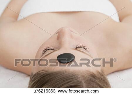 Woman receiving la stone therapy View Large Photo Image Stock Image - Woman receiving la stone therapy. Fotosearch