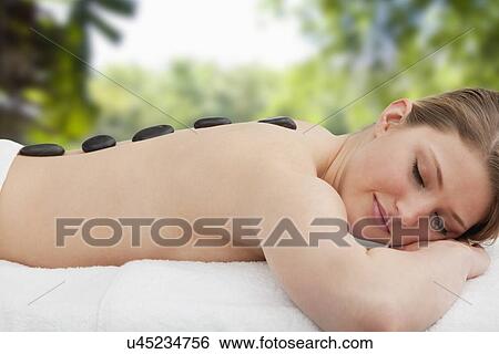 Woman receiving la stone therapy View Large Photo Image Stock Photograph - Woman receiving la stone therapy. Fotosearch
