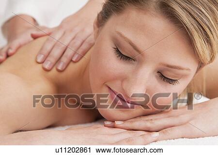 Stock Image - Woman receiving massage. Fotosearch