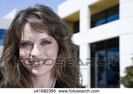Stock Photography - Woman smiling outdoors, portrait. Fotosearch