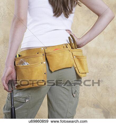 Woman wearing tool belt, mid section, rear view View Large Photo Image Stock Photo - Woman wearing tool belt, mid section, rear view. Fotosearch
