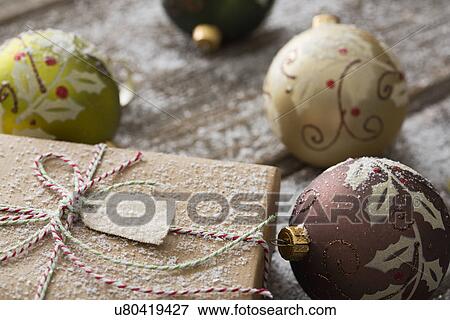 Wrapped gift and Christmas ornaments View Large Photo Image Stock Photo - Wrapped gift and Christmas ornaments. Fotosearch