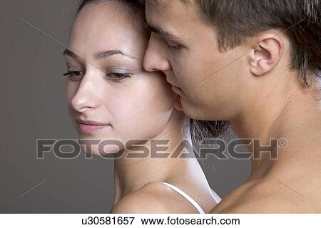 Young couple embracing View Large Photo Image Stock Photo - Young couple embracing. Fotosearch