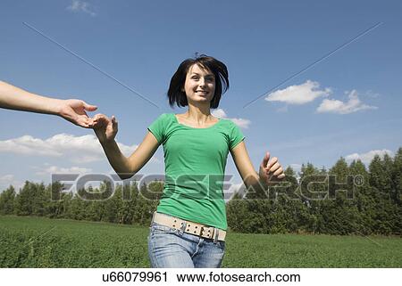 Young couple running trough field View Large Photo Image Stock Image - Young couple running trough field. Fotosearch