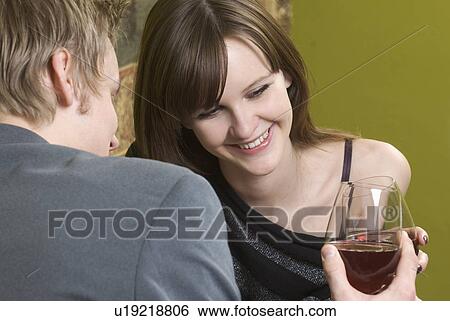 Young couple toasting with red wine View Large Photo Image Stock Photograph - Young couple toasting with red wine. Fotosearch