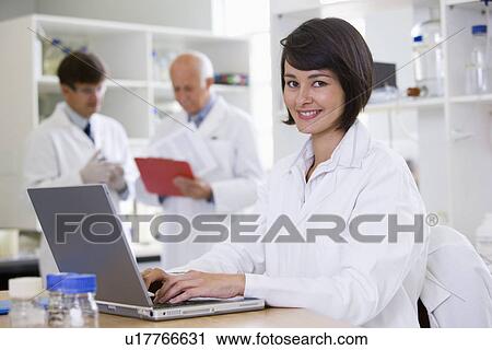 Stock Image - Young female scientist. Fotosearch