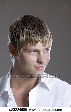 Stock Photograph - Young man in open collar shirt. Fotosearch