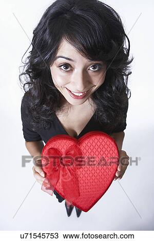Young woman holding love heart box, portrait View Large Photo Image Stock Image - Young woman holding love heart box, portrait. Fotosearch