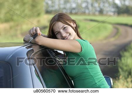 Young woman leaning pn car on country road View Large Photo Image Stock Image - Young woman leaning pn car on country road. Fotosearch