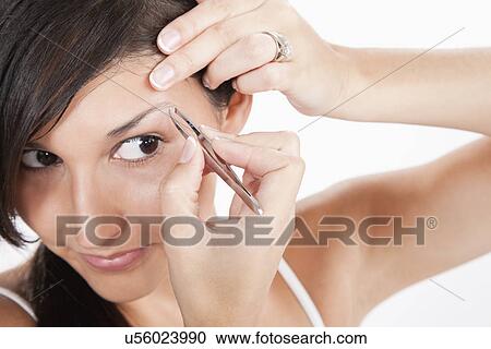 Young woman removing eyebrows View Large Photo Image Stock Image - Young woman removing eyebrows. Fotosearch
