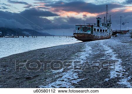 Stock Image - Ships and shipwrecks in Ushuaia harbour, Argentina. Fotosearch