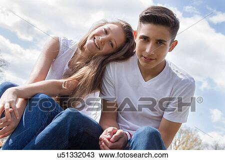 Stock Image - Angled portrait of teenage couple. Fotosearch