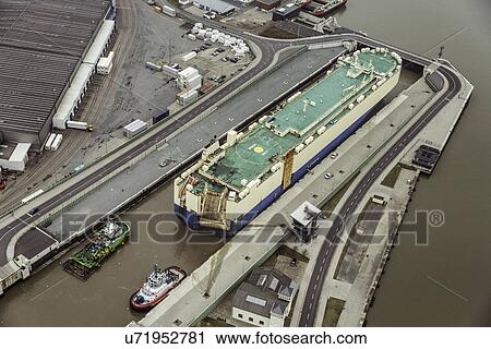 Stock Image - Auto transporter in a lock, Bremerhaven, Germany. Fotosearch