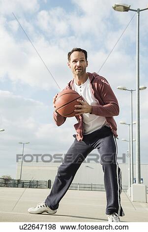 Basketball player about to throw basketball View Large Photo Image Stock Photo - Basketball player about to throw basketball. Fotosearch