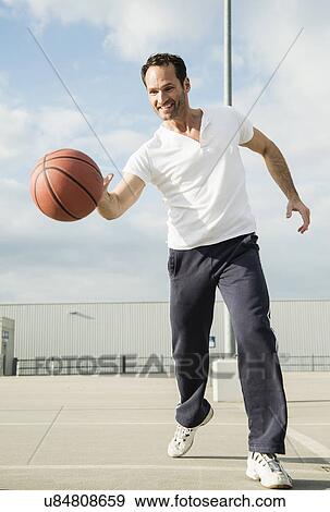 Basketball player dribbling basketball View Large Photo Image Stock Photo - Basketball player dribbling basketball. Fotosearch