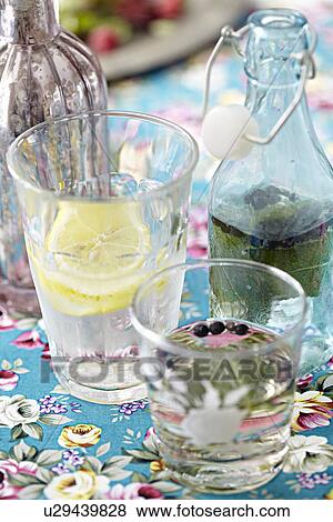 Bottles and glasses of homemade drink View Large Photo Image Stock Photo - Bottles and glasses of homemade drink. Fotosearch
