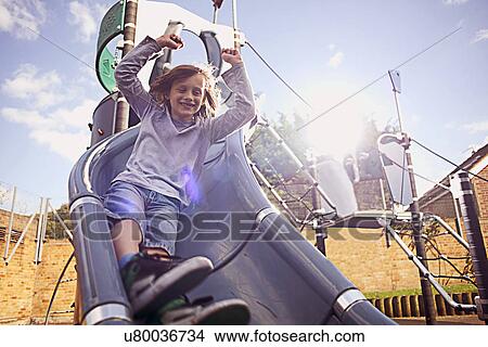 Boy coming down slide View Large Photo Image Picture - Boy coming down slide. Fotosearch