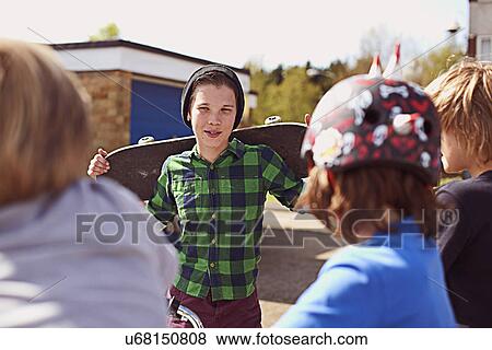 Boy holding skateboard View Large Photo Image Stock Photo - Boy holding skateboard. Fotosearch