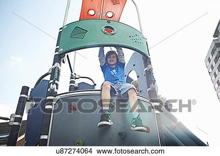 Picture - Boy on climbing frame. Fotosearch