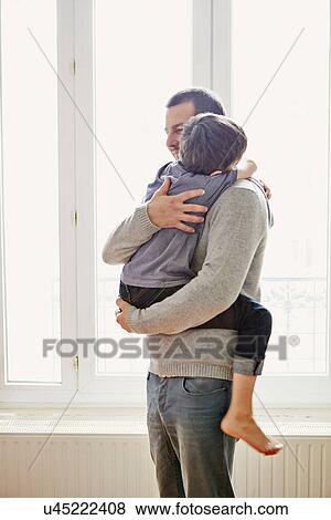 Stock Photo - Boy showing affection to father. Fotosearch