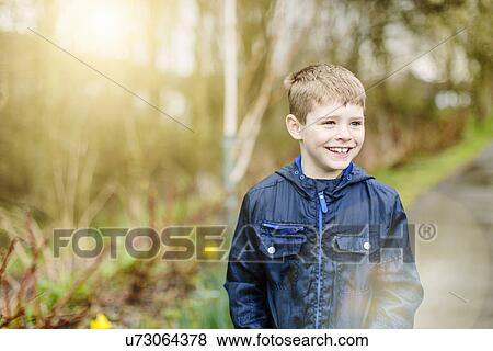 Boy standing outdoors View Large Photo Image Stock Photo - Boy standing outdoors. Fotosearch