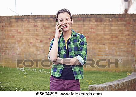 Boy using cell phone View Large Photo Image Stock Photo - Boy using cell phone. Fotosearch