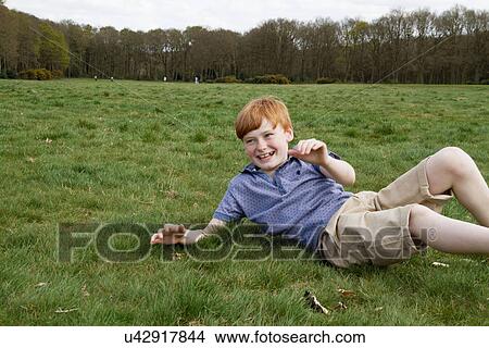 Boys playing in field View Large Photo Image Picture - Boys playing in field. Fotosearch
