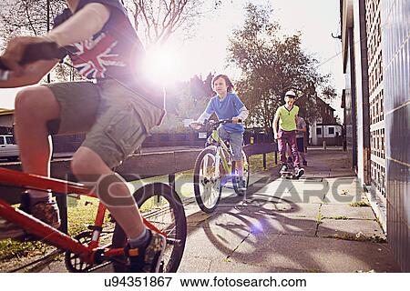 Stock Photo - Boys riding bikes. Fotosearch
