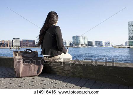 Business woman taking break by waterfront, Copenhagen, Denmark View Large Photo Image Stock Photograph - Business woman taking break by waterfront, Copenhagen, Denmark. Fotosearch