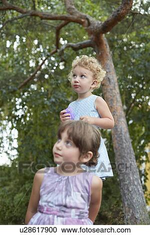 Candid portrait of two young sisters looking up View Large Photo Image Stock Image - Candid portrait of two young sisters looking up. Fotosearch