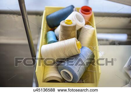 Stock Photo - Close up of coloured threads in fashion studio. Fotosearch