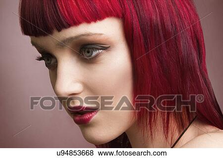 Stock Photo - Close up studio portrait of young woman with pink hair. Fotosearch