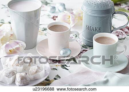 Stock Photo - Coffee cups and sweet treats. Fotosearch