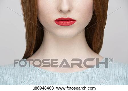 Stock Image - Cropped image of young woman's lips. Fotosearch