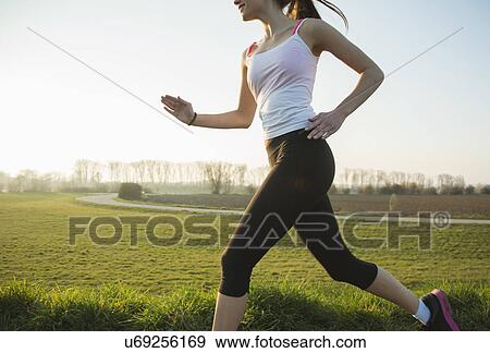 Cropped shot of young female runner View Large Photo Image Stock Photo - Cropped shot of young female runner. Fotosearch