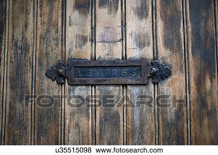 Stock Photo - Detail of rustic letterbox and wooden door. Fotosearch