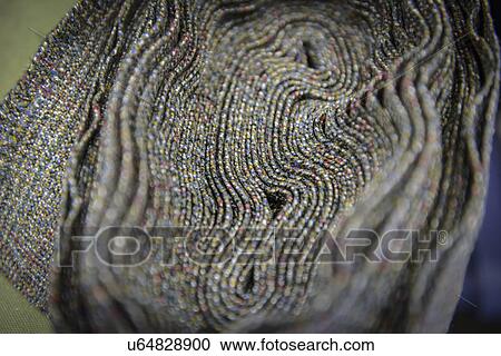Stock Image - Detail of tweed edge in clothing factory, close up. Fotosearch