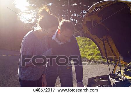 Stock Photo - Driving instructor and pupil checking car engine. Fotosearch