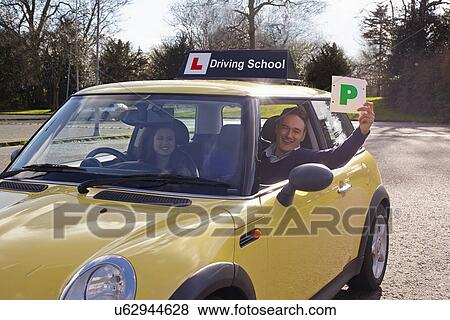 Driving instructor holding Passed Plate out of car window View Large Photo Image Stock Photo - Driving instructor holding Passed Plate out of car window. Fotosearch