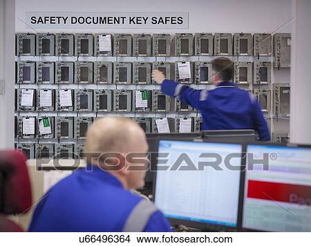 Engineer selecting equipment keys in power station View Large Photo Image Picture - Engineer selecting equipment keys in power station. Fotosearch