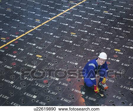 Engineer using sensors on pile cap in nuclear power station, portrait View Large Photo Image Stock Image - Engineer using sensors on pile cap in nuclear power station, portrait. Fotosearch