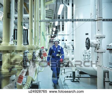 Engineer walking amongst pipes of nuclear power station View Large Photo Image Stock Photography - Engineer walking amongst pipes of nuclear power station. Fotosearch