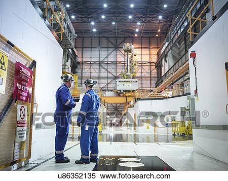 Engineers in discussion in reactor hall in nuclear power station View Large Photo Image Stock Photography - Engineers in discussion in reactor hall in nuclear power station. Fotosearch