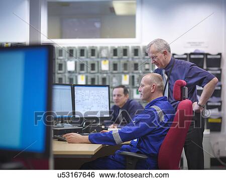 Stock Photograph - Engineers in meeting in nuclear power station. Fotosearch