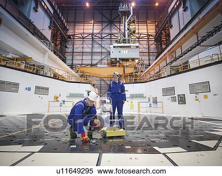 Stock Photography - Engineers using sensors on pile cap in nuclear power station. Fotosearch