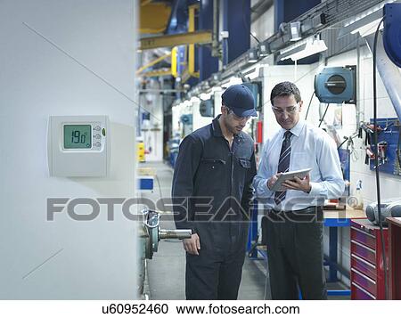 Factory and office worker discussing energy saving in factory View Large Photo Image Stock Image - Factory and office worker discussing energy saving in factory. Fotosearch