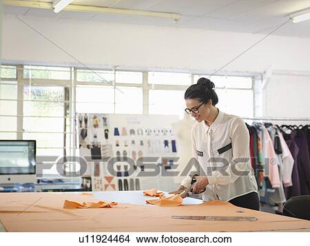 Fashion designer cutting cloth in fashion design studio View Large Photo Image Picture - Fashion designer cutting cloth in fashion design studio. Fotosearch