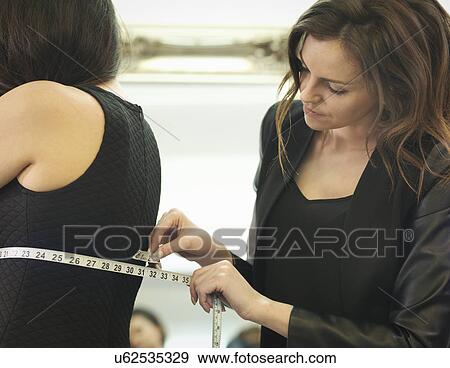 Fashion designer measuring clothing in fashion design studio View Large Photo Image Stock Photo - Fashion designer measuring clothing in fashion design studio. Fotosearch