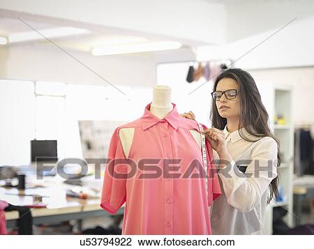 Fashion designer measuring garment in fashion design studio View Large Photo Image Stock Image - Fashion designer measuring garment in fashion design studio. Fotosearch